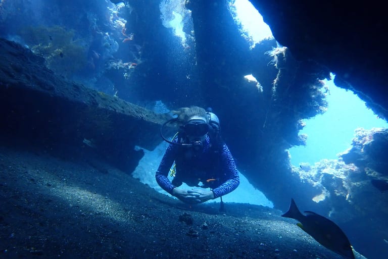 Diver exploring inside the USAT Liberty Wreck in Tulamben, Bali