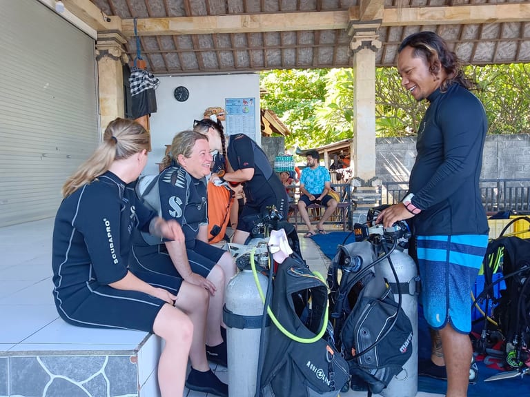 PADI dive instructor teaching students about scuba equipment at Scuba Odessey in Amed